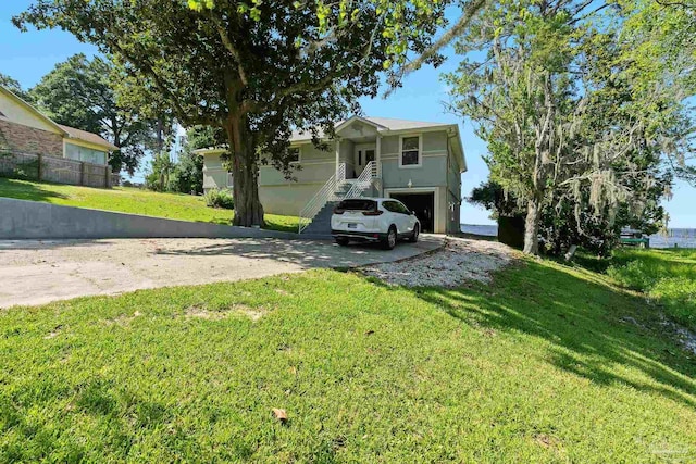 view of front of property with a garage and a front yard