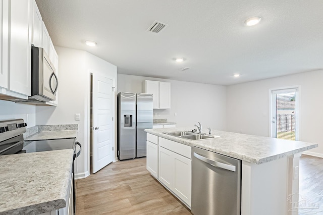 7581 Steeplechase Blvd, Pensacola, FL 32526 - kitchen featuring stainless steel appliances, light wood-style flooring, light countertops, white cabinetry, and recessed lighting