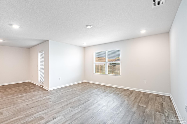 7581 Steeplechase Blvd, Pensacola, FL 32526 - unfurnished room featuring wood finished floors, a textured ceiling, and recessed lighting