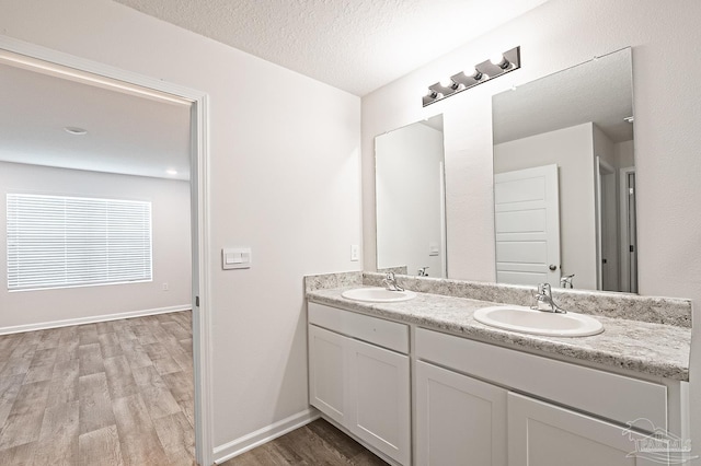 7581 Steeplechase Blvd, Pensacola, FL 32526 - full bath with double vanity, wood finished floors, and a textured ceiling