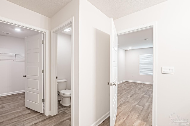 7581 Steeplechase Blvd, Pensacola, FL 32526 - corridor featuring wood finished floors and a textured ceiling