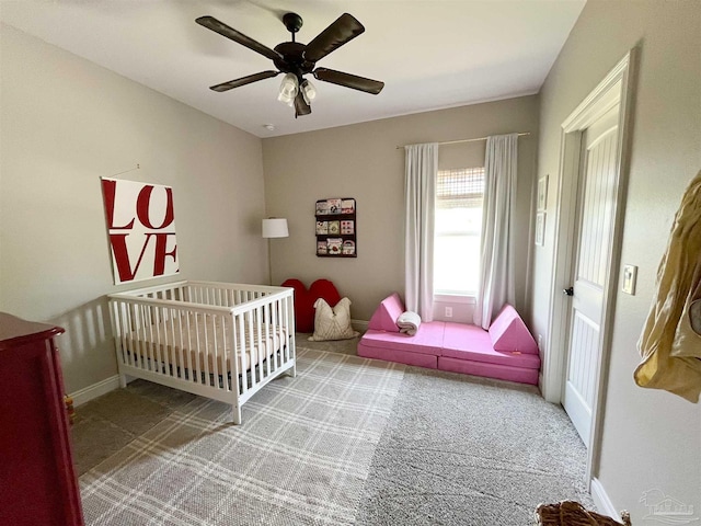 carpeted bedroom with a ceiling fan and baseboards
