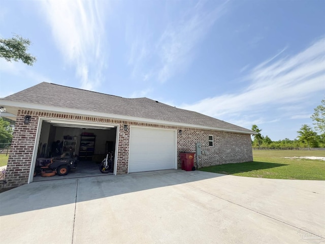view of property exterior featuring driveway, brick siding, an attached garage, a shingled roof, and a lawn
