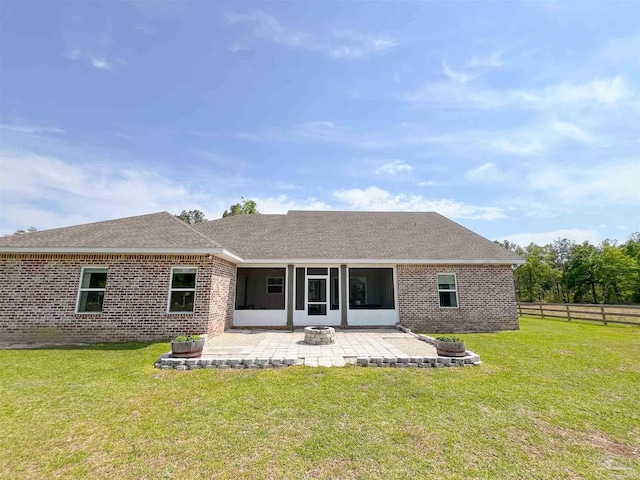 back of house featuring a patio area, a shingled roof, fence, a yard, and brick siding