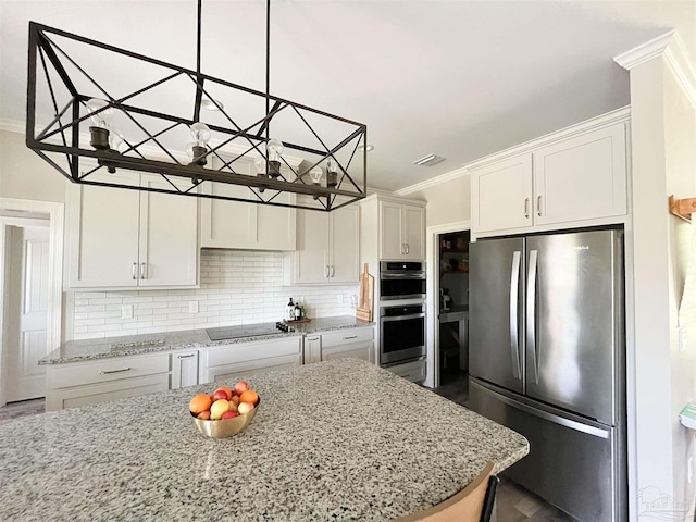 kitchen featuring visible vents, ornamental molding, appliances with stainless steel finishes, and tasteful backsplash
