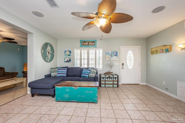 interior space with light tile patterned floors and ceiling fan