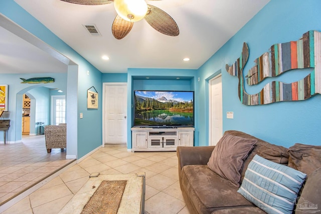 tiled living room with ceiling fan