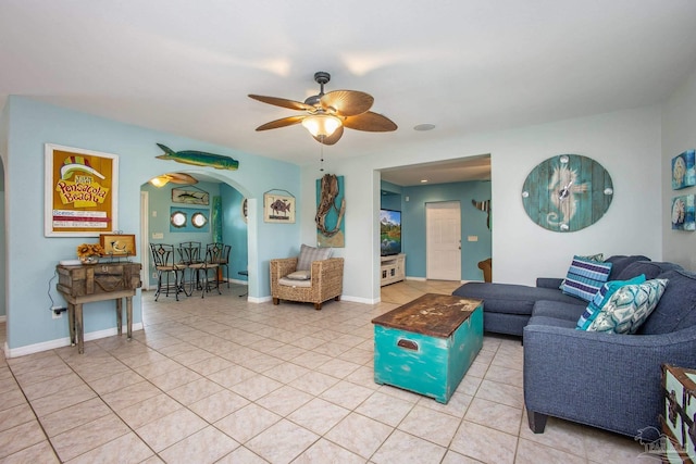 living room featuring light tile patterned floors and ceiling fan