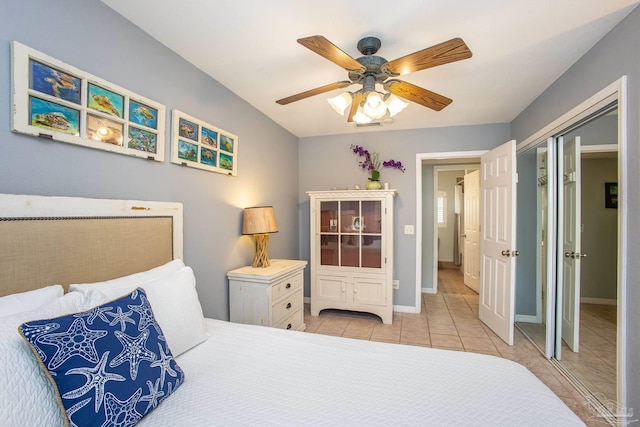 bedroom featuring ceiling fan, a closet, and light tile patterned floors