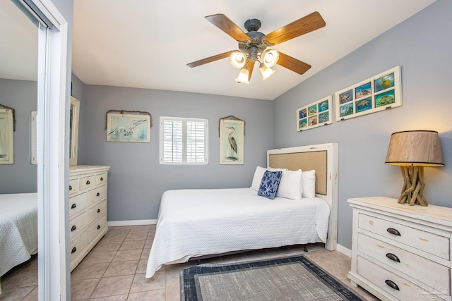 bedroom featuring light tile patterned flooring and ceiling fan