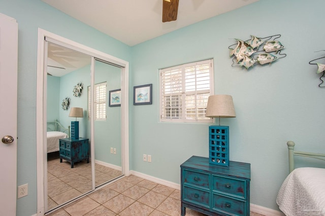 tiled bedroom with a closet and ceiling fan