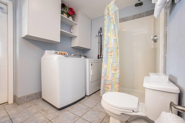 bathroom featuring washing machine and dryer, tile patterned flooring, and toilet