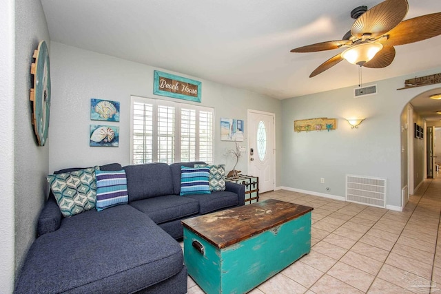 tiled living room featuring ceiling fan