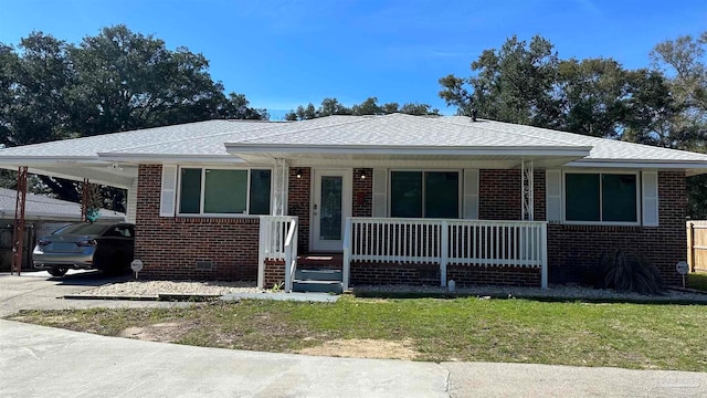 view of front of house featuring a carport, a front yard, and a porch