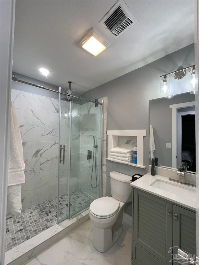 bathroom featuring vanity, toilet, and a shower with door