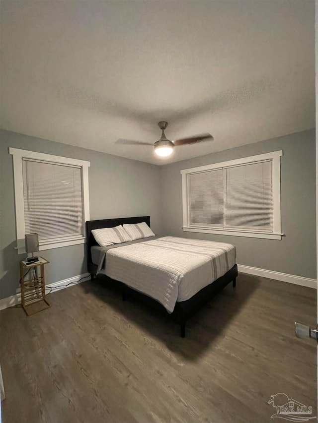 bedroom featuring dark wood-type flooring and ceiling fan