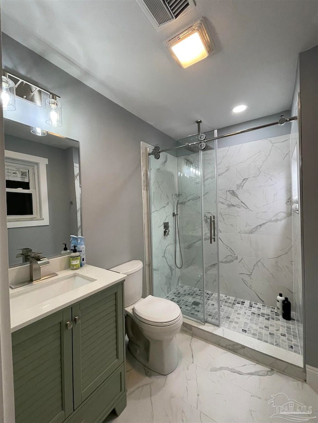 bathroom with a shower with door, vanity, and toilet