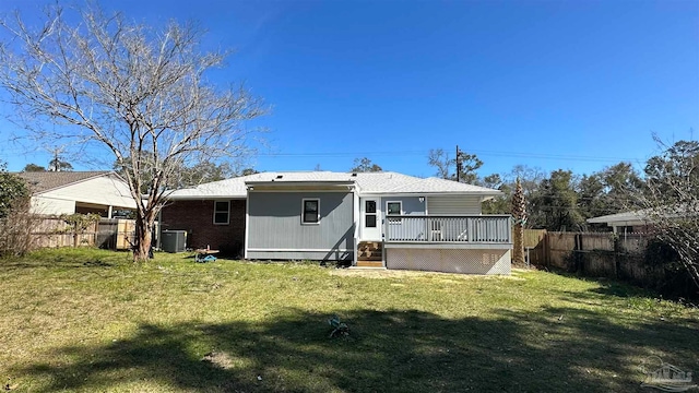 back of house featuring a yard, a deck, and central air condition unit