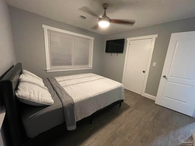 bedroom featuring ceiling fan and dark hardwood / wood-style flooring