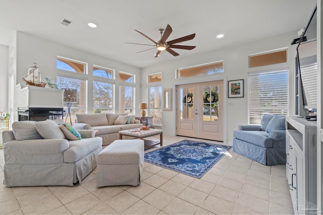 living room featuring french doors, ceiling fan, and light tile patterned floors