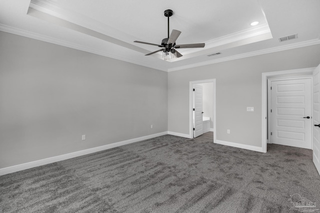 carpeted spare room with a raised ceiling, ceiling fan, and crown molding