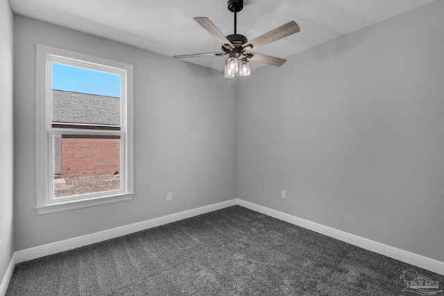 carpeted spare room featuring ceiling fan