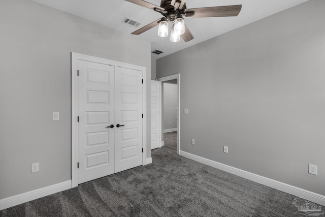 unfurnished bedroom featuring ceiling fan, a closet, and dark carpet