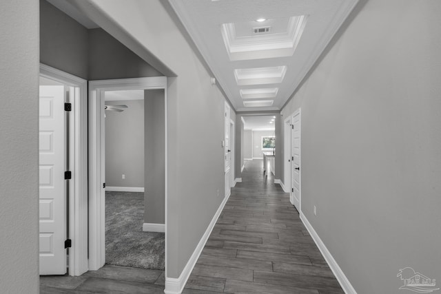 corridor with dark hardwood / wood-style flooring and ornamental molding