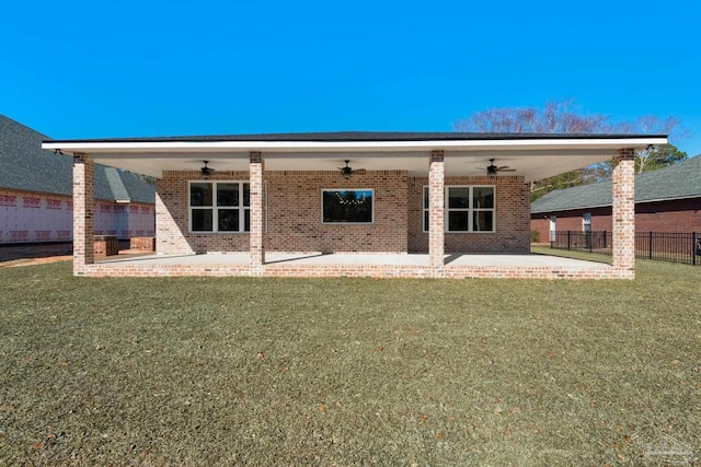 rear view of house with a lawn, ceiling fan, and a patio