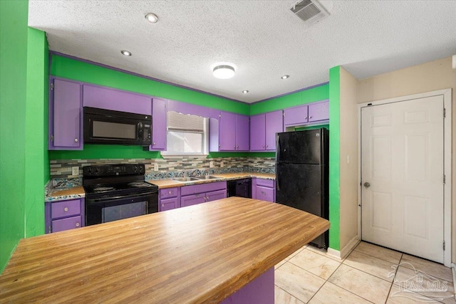 kitchen featuring sink, light tile patterned floors, a textured ceiling, and black appliances