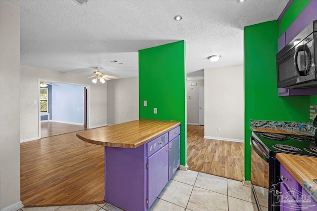 kitchen featuring kitchen peninsula, a textured ceiling, black / electric stove, ceiling fan, and light tile patterned flooring