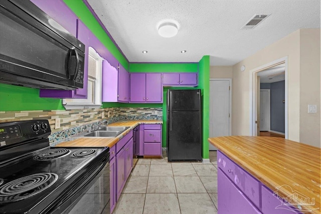 kitchen with black appliances, a textured ceiling, sink, light tile patterned flooring, and tasteful backsplash