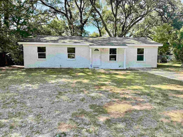 ranch-style home with a front lawn