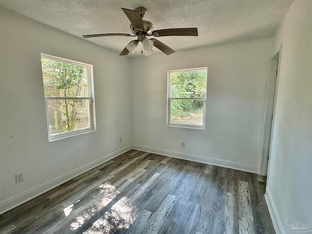 empty room with a textured ceiling, dark wood-type flooring, and ceiling fan