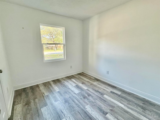 empty room featuring light hardwood / wood-style flooring and a textured ceiling