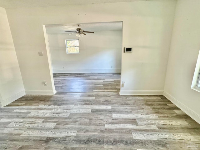 unfurnished room with ceiling fan and light wood-type flooring