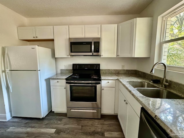 kitchen with sink, white cabinets, stainless steel appliances, and dark hardwood / wood-style flooring