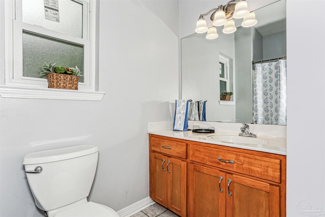 3640 Schifko Rd, Cantonment, FL 32533 - full bath featuring toilet, vanity, tile patterned flooring, baseboards, and a chandelier