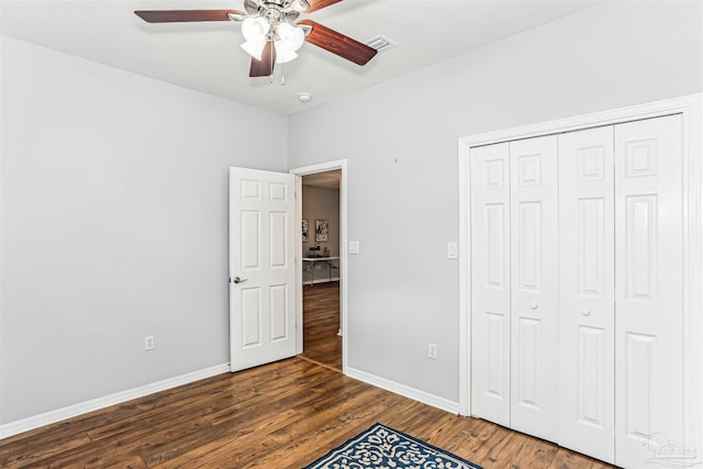 3640 Schifko Rd, Cantonment, FL 32533 - unfurnished bedroom with wood finished floors, baseboards, a closet, and a ceiling fan