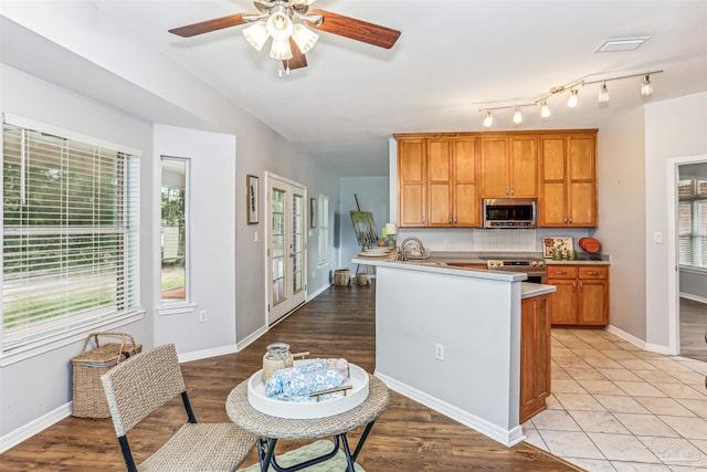 3640 Schifko Rd, Cantonment, FL 32533 - kitchen featuring appliances with stainless steel finishes, healthy amount of natural light, a ceiling fan, and a peninsula