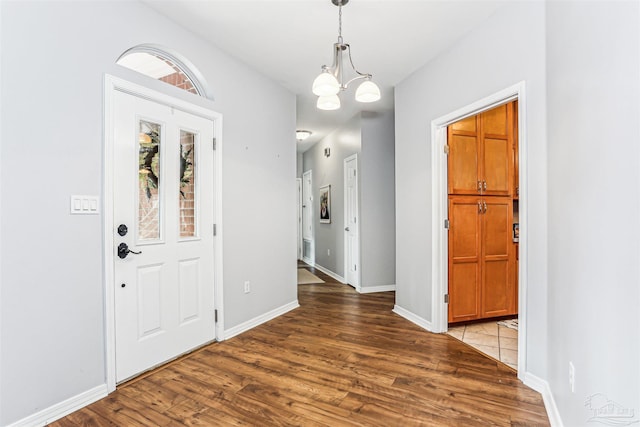 3640 Schifko Rd, Cantonment, FL 32533 - entrance foyer featuring wood finished floors, a chandelier, and baseboards