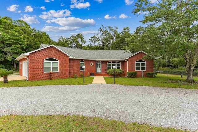 3640 Schifko Rd, Cantonment, FL 32533 - single story home featuring brick siding, gravel driveway, and an attached garage