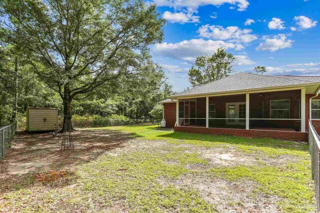 3640 Schifko Rd, Cantonment, FL 32533 - view of yard with a sunroom, an outdoor structure, and a shed