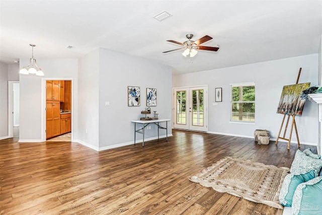 3640 Schifko Rd, Cantonment, FL 32533 - living room featuring wood finished floors, ceiling fan, a chandelier, and baseboards