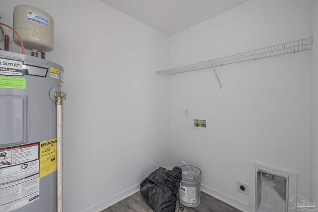 clothes washing area with laundry area, wood finished floors, hookup for an electric dryer, water heater, and washer hookup