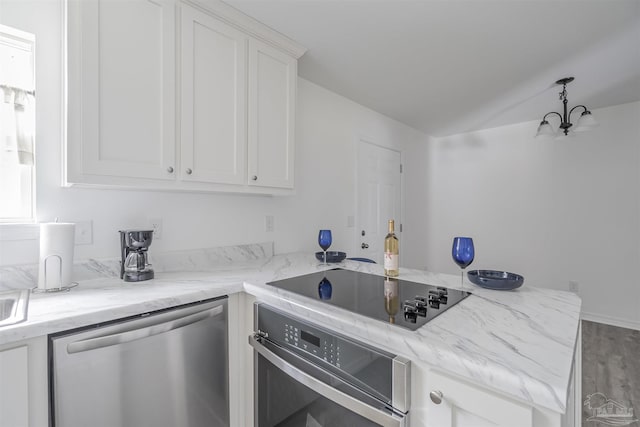 kitchen featuring a peninsula, appliances with stainless steel finishes, and white cabinets