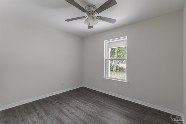 unfurnished room featuring dark wood finished floors, baseboards, and ceiling fan