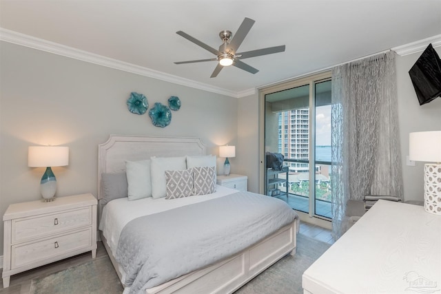 bedroom with ornamental molding, access to outside, wood finished floors, floor to ceiling windows, and ceiling fan