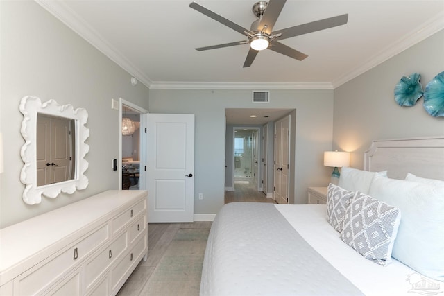 bedroom with light wood-type flooring, visible vents, ornamental molding, a ceiling fan, and connected bathroom