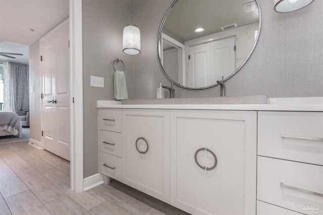 full bathroom featuring vanity, visible vents, wood tiled floor, recessed lighting, and connected bathroom
